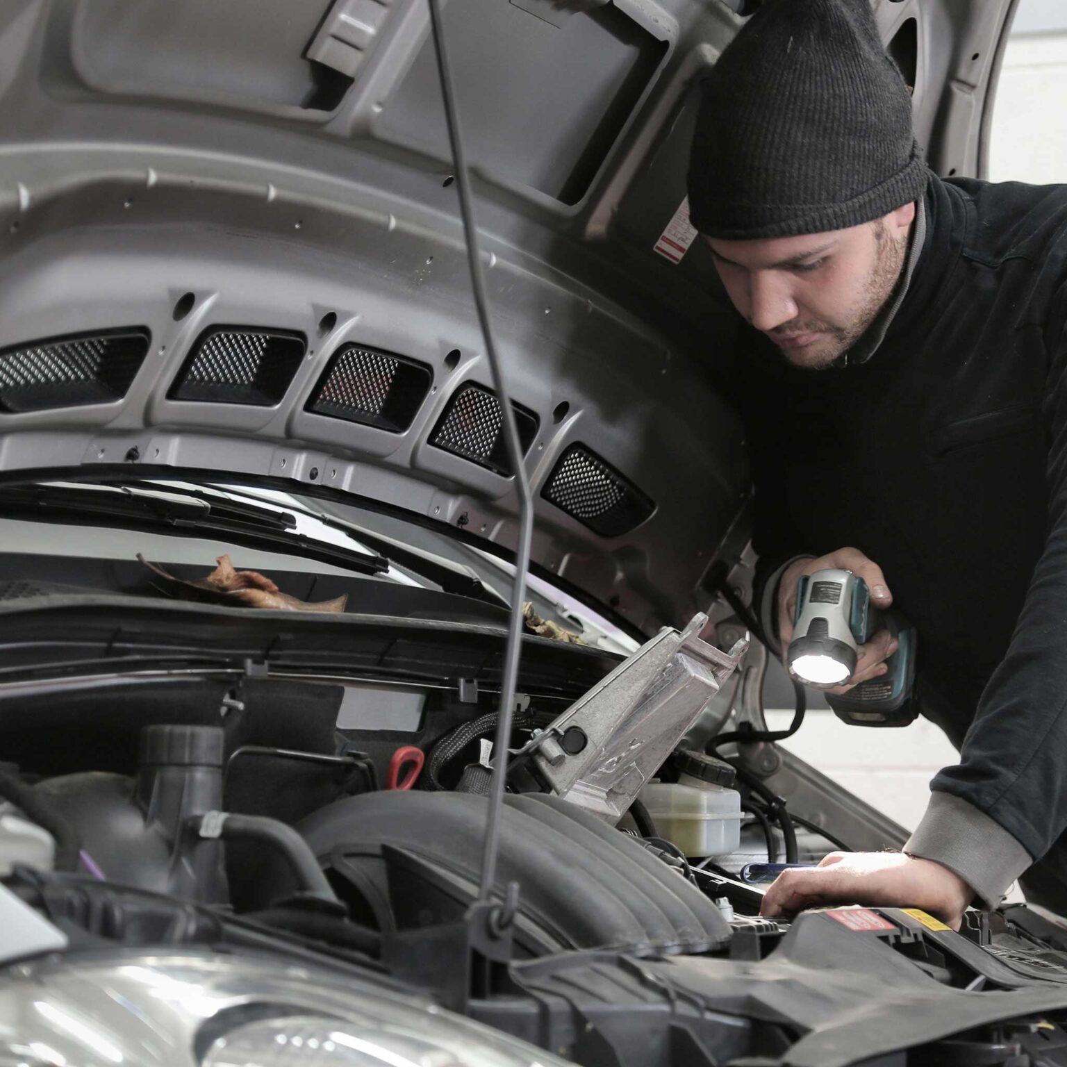 Botley Road Motors your Oxford garage | Mechanic working on engine from the side